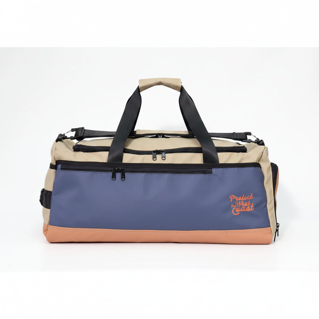 A color-blocked duffle bag by Protect-The-West-Coast featuring a navy blue front panel, a beige top section, and a tan bottom base, with black straps and zippers.