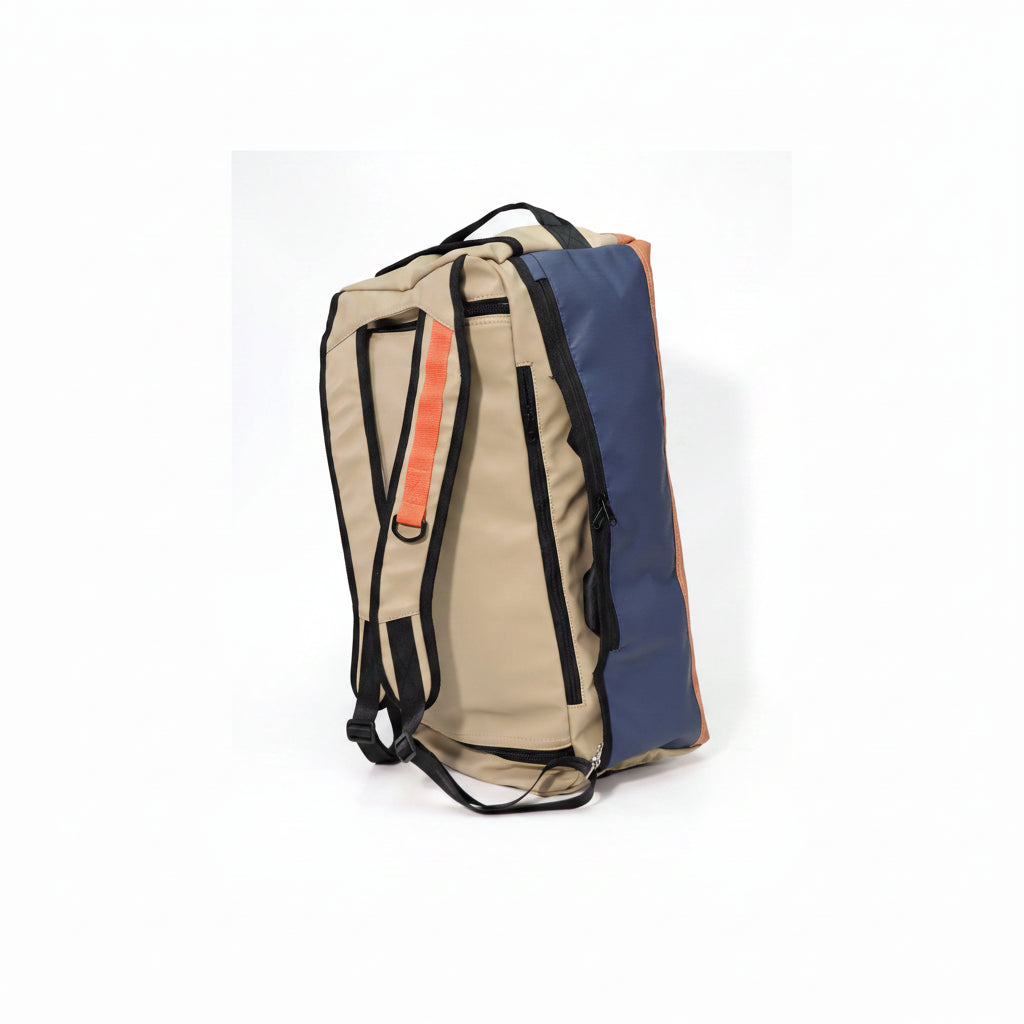 A Protect The West Coast Sealand duffel bag with a beige front, a navy blue side panel, and orange accents, shown from a three-quarter angle on a white background.