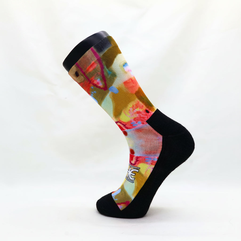 Trail socks with mohair blend toe, heel, and cuff, featuring a vibrant multicolor abstract pattern on the leg and foot.